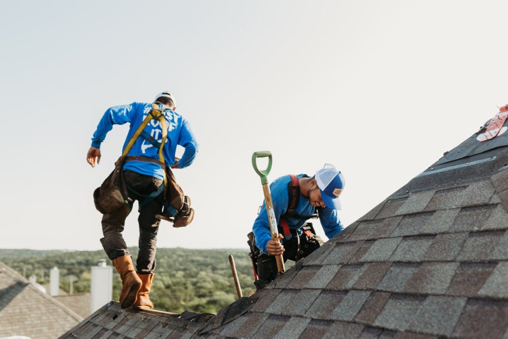 members of bondoc roofing team working on roof repair